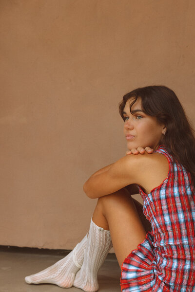 Relaxed brand portrait captured by Sunshine Coast photographer, featuring a woman enjoying coffee in a soft-lit setting.
