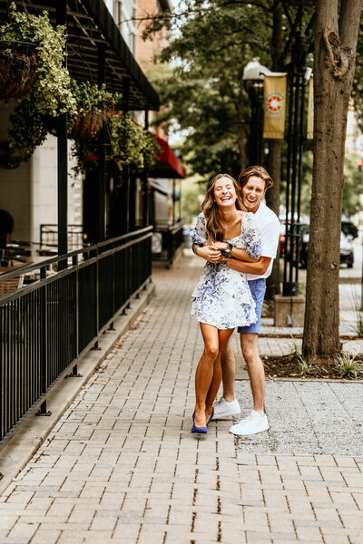 The bride's side profile standing in front of the church with her dress train fluffed out trailing behind her and looking behind over her shoulder