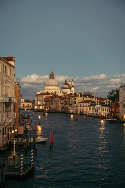 Dusk from Accademia Bridge: A serene view captures the tranquil beauty of Venice as day transitions to night from the iconic Accademia Bridge