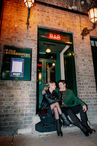 couple sits on bar steps