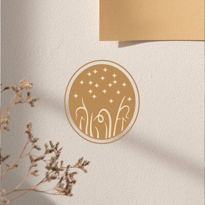 An oval shaped logo with imagery of a starry sky and curly, native grasses.