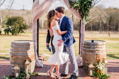 A bride and groom share a kiss at the end of their wedding at Fleetwood Farm Winery in Northern Virginia
