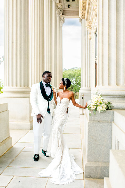 Capture the heartwarming moment of a Black bride smiling at her father as he walks her down the aisle. This touching image embodies love, joy, and family bonds on a special wedding day.