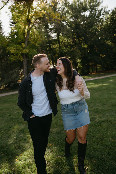 Couples session in field at sunset