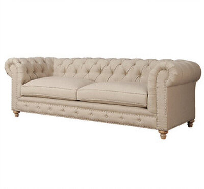cream tufted sofa