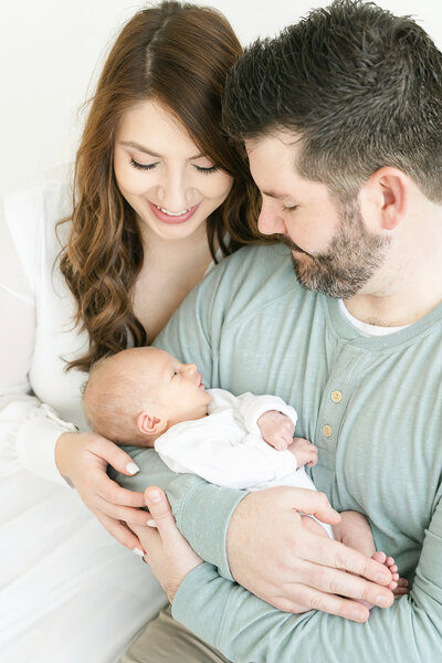 A candid moment shared between parents and their newborn baby at Julie Brock Photography in Louisville KY