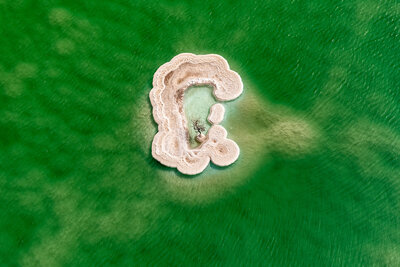 green water surrounding island from above