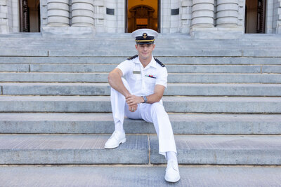 USNA Midshipman in white uniform on the steps of Bancroft Hall for photo by Kelly Eskelsen.