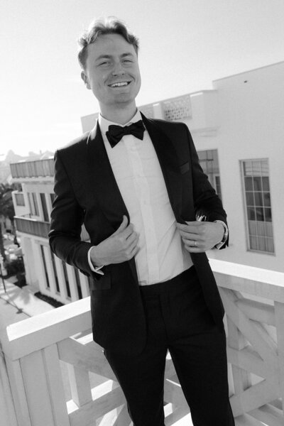 groom showing off his suit at wedding