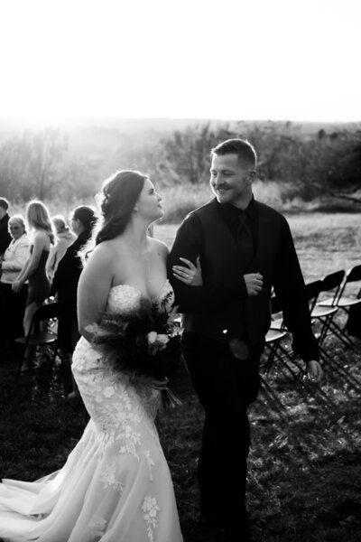 bride and groom looking at each other right after they said i do and walking back down the isle.