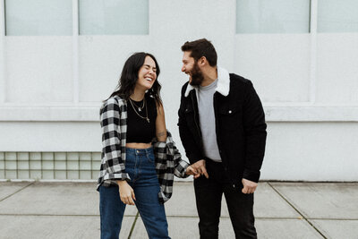 couple holding hands laughing