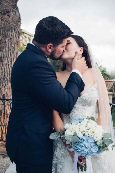 A bride and groom walking down the aisle in a burgundy suit, captured by Britt Elizabeth destination wedding photography.