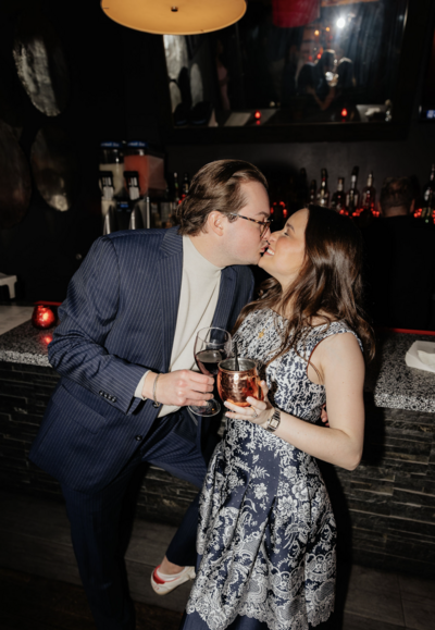couple embraces at their wedding rehearsal dinner in texas