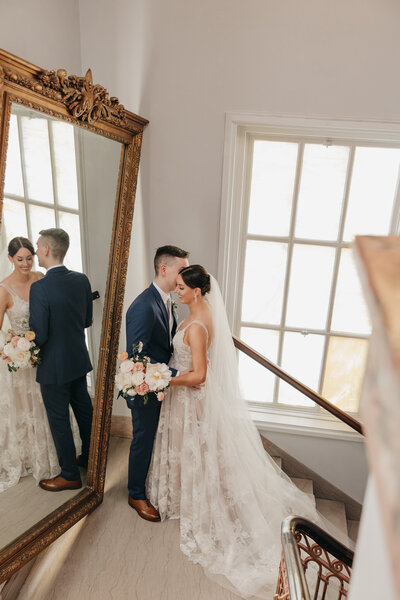 bride and groom looking at each other with flower girls standing in front of them