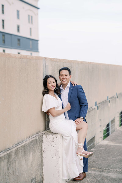 image of a couple leaning on the walls of Downtown Austin Rooftop and South Congress Bat Bridge