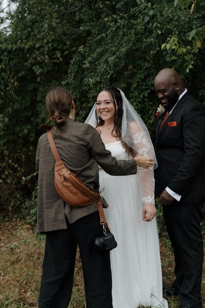 wedding photographer fixing brides veil