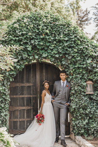 Wedding Photographer & Elopement Photographer, bride and groom standing under arch