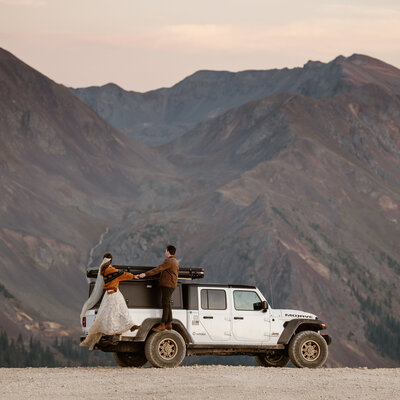 Husband & Wife posing with Jeep Gladiator on Overland wedding in Telluride, CO