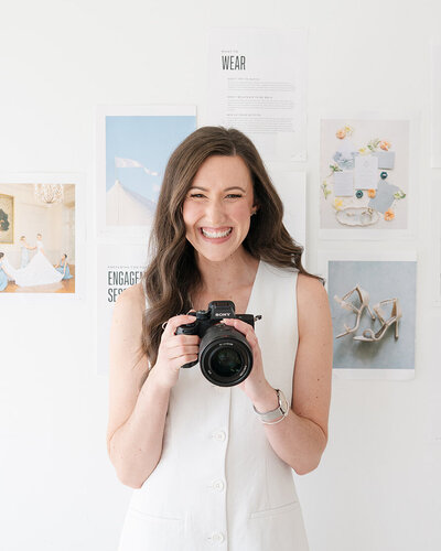Massachusetts wedding  photographer meghan lynch holding a sony and smiling at the camera during a portrait session