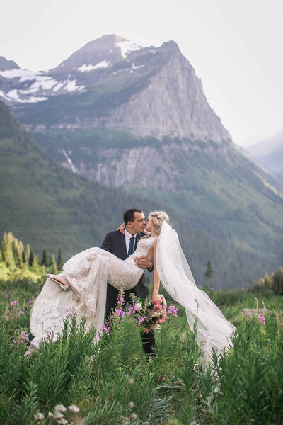 groom holding bride in arms