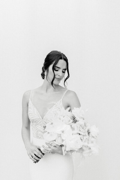 A bride poses for a photo holding her bouquet at Barn South in Pendergrass, GA