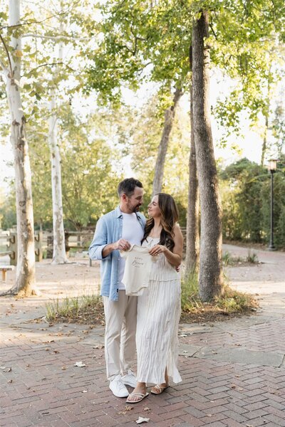 Couple holding hands wading in ocean