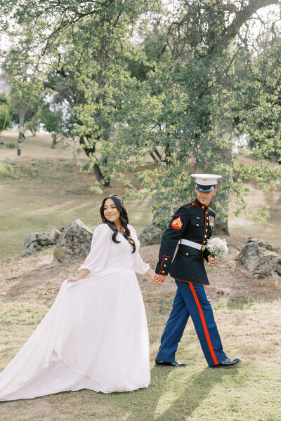 Couple walking along trail during wildflower elopement session