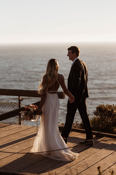 bride and groom walking at sunset