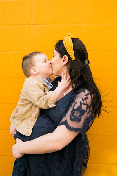 Photo of Mother and Son In Front of Orange Wall | Maine Photographer