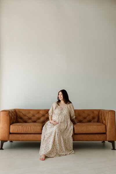 pregnant woman posing at on a couch