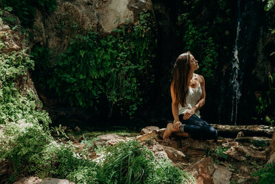 photo of lady looking peaceful at a hidden waterfall in Zion National Park 