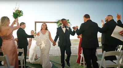 Bride and groom celebrate their beach wedding at the Sandpearl resort in Florida.