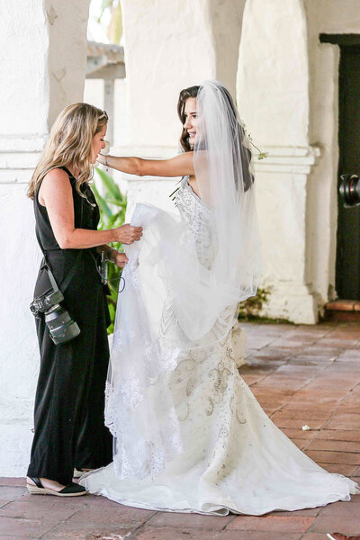 san diego wedding photographer helping bride