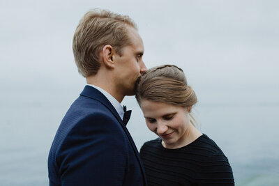 Eloping couple standing facing each other heads together in Helsinki in Finland