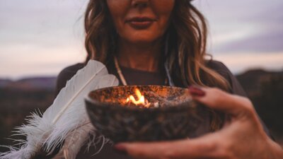 Woman with sage and feather shamanic practioner Dana Haines spiritual energy healer womens wellness retreats