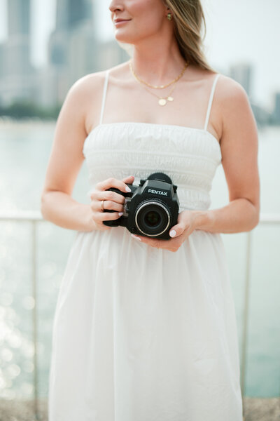 woman holds camera
