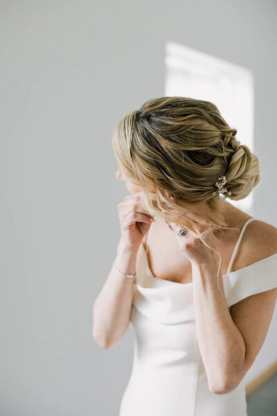 A bridal hairstylist based in western PA and beyond showcasing bride's updo.