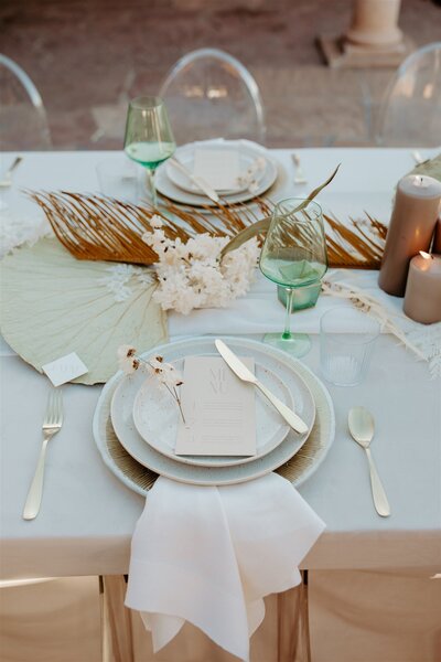 tropical tablescape with palm leaves and white flowers