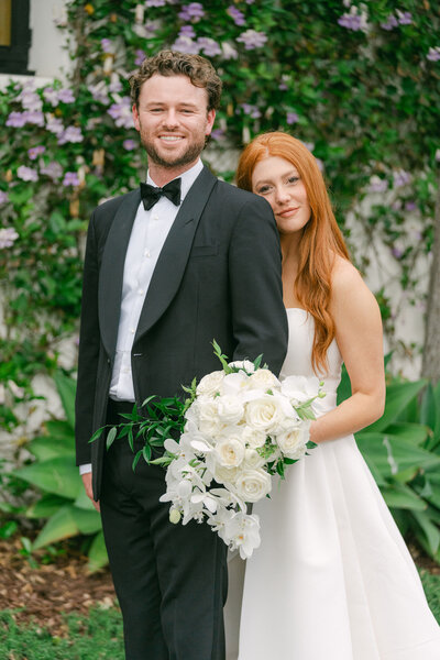 groom in a traditional black tux  bride in a custom Monique Lhuillier gown gazing into each other's eyes in front of El Encanto a Belmond Hotel  captured by Los Angeles Wedding Photographer Magnolia West Photography