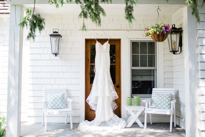 Wedding dress hanging on hanger on door