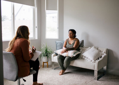 Therapist sitting in her office talking with a woman