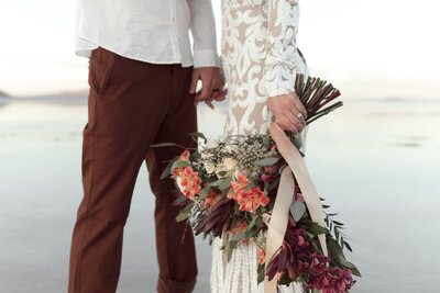 bride and groom holding hands