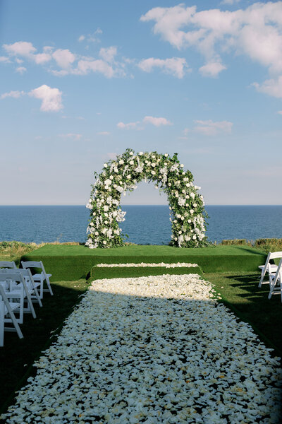 A floral arch with Lake Michigan in the background.