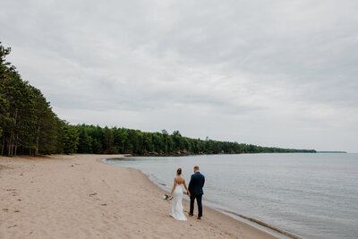 Drone Photo of Bride and Groom Dancing on Shoreline of Lake Superior on Madeline Island in Wisconsin