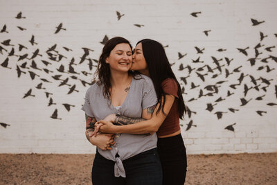 A lesbian couple share a loving embrace.