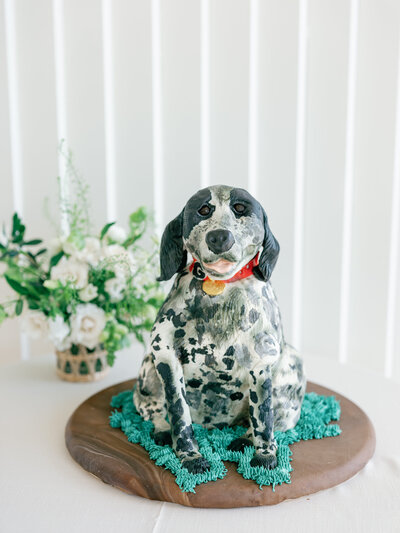Wedding cake that's painted to look like the bride and groom's dog