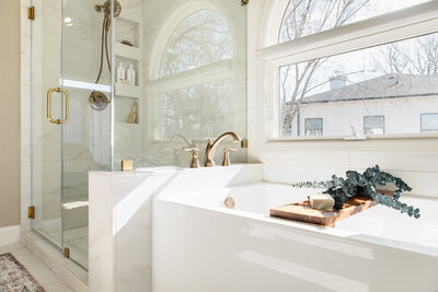Bright and airy primary bathroom with walk in shower, soaker tub, window seating and large vanity.