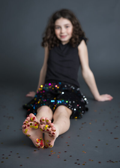 Dark and moody photo of a girl covered in glitter in a Union County, NJ photo studio.