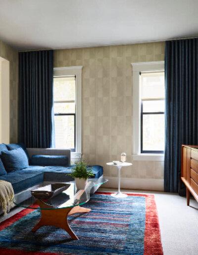Boston interior designer updates a historic Brookline home with eclectic furniture, curated art, and layered textures, blending vintage and contemporary style.