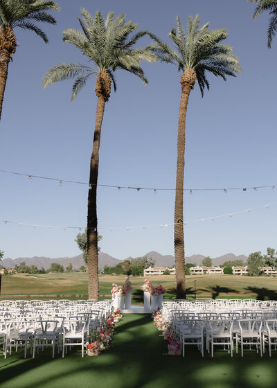 Colorful ceremony wedding flowers and aisle by the lakeside designed by Snapdragon Bloom Bar & Hudson Grey Weddings.
